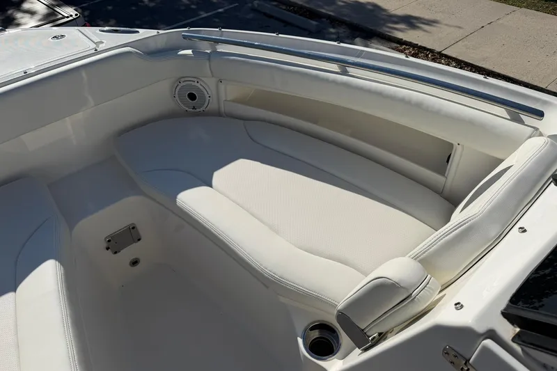 Slide: The Image of 2021 Pursuit DC 266 Dual Console boat interior with white cushioned seating. - 27