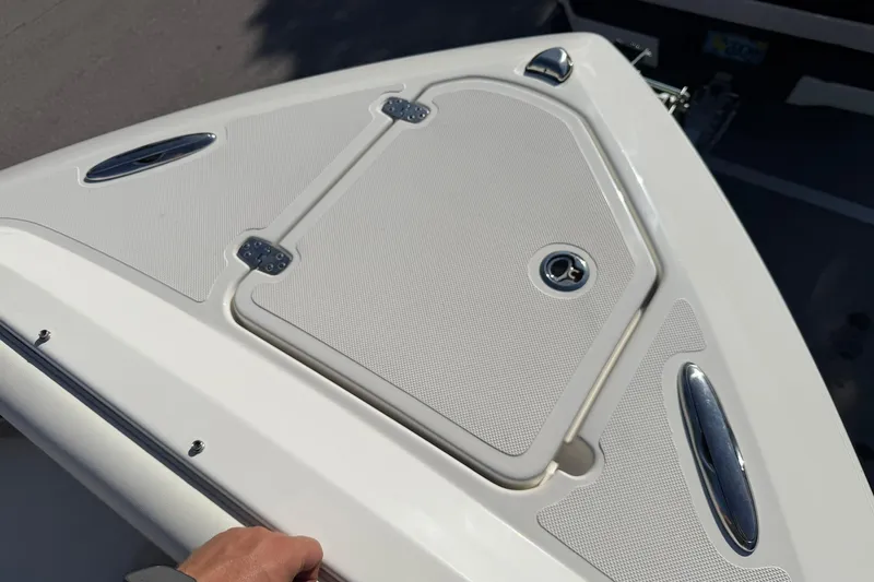 Slide: The Image of 2021 Pursuit DC 266 Dual Console boat deck with storage compartment and sleek design. - 28