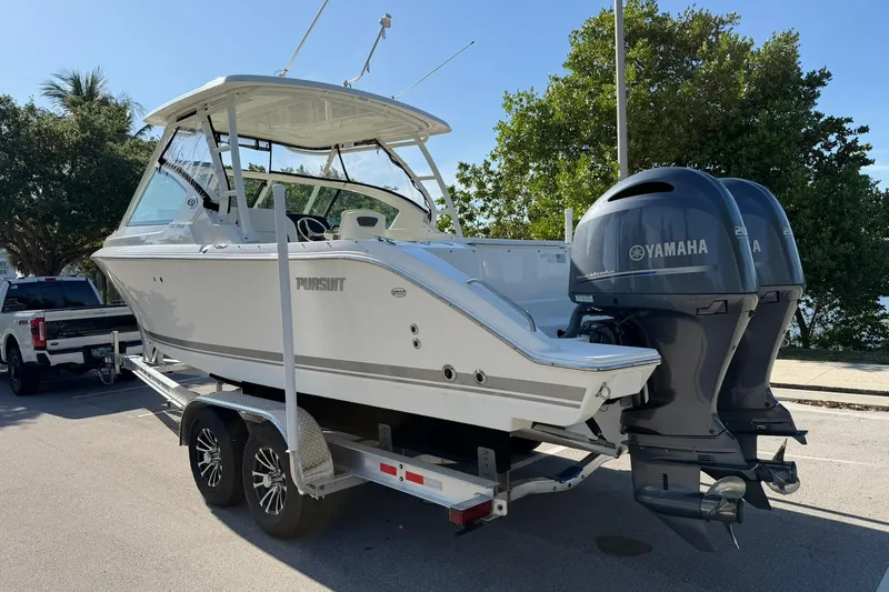 Slide: The Image of 2021 Pursuit DC 266 Dual Console boat on trailer with Yamaha engines. - 3