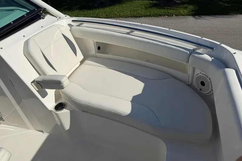 Slide: The Image of 2021 Pursuit DC 266 Dual Console boat with white cushioned seating area. - 31