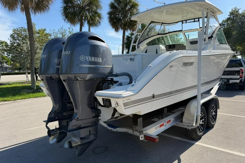 Slide: The Image of 2021 Pursuit DC 266 Dual Console boat with twin Yamaha engines on a trailer. - 5