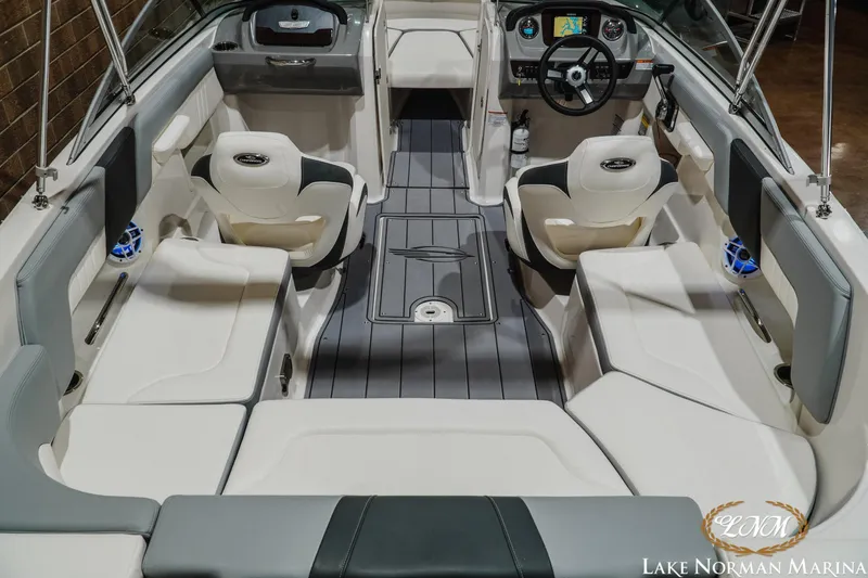 Slide: The Image of 2023 Chaparral 23 SSi boat interior with modern seating and dashboard at Lake Norman Marina. - 10