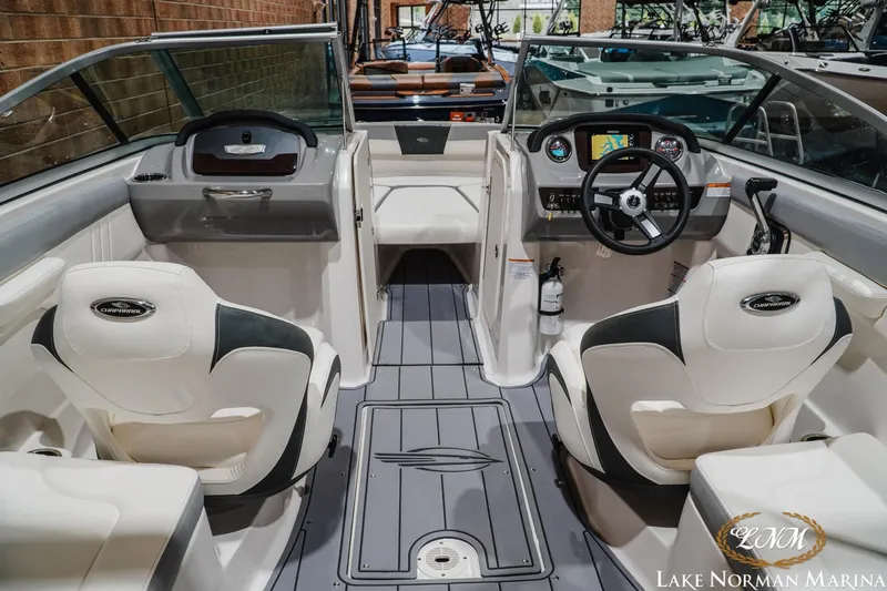 Slide: The Image of 2023 Chaparral 23 SSi boat interior with dual seating and modern dashboard at Lake Norman Marina. - 11