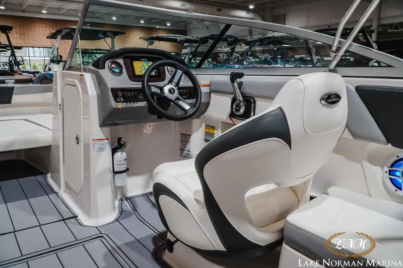 Slide: The Image of 2023 Chaparral 23 SSi boat interior with steering wheel and dashboard at Lake Norman Marina. - 12