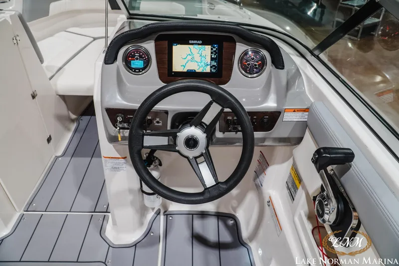 Slide: The Image of 2023 Chaparral 23 SSi boat dashboard with steering wheel and navigation display. - 13