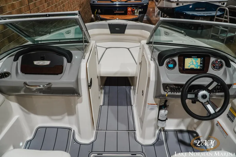 Slide: The Image of 2023 Chaparral 23 SSi boat interior with steering wheel and navigation display. - 15