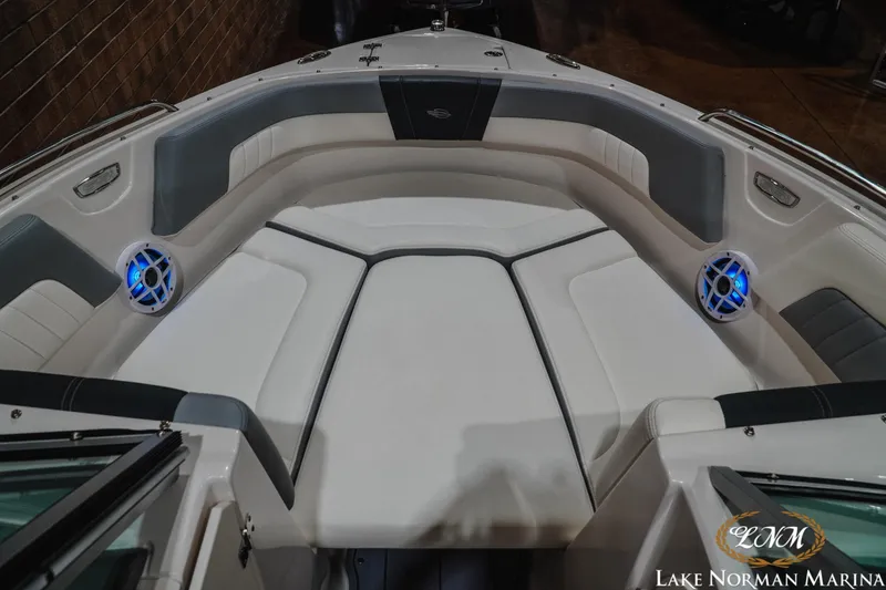 Slide: The Image of 2023 Chaparral 23 SSi boat interior with cushioned seating and blue LED speakers. - 16