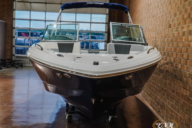 Slide: The Image of 2023 Chaparral 23 SSi boat in showroom, front view, sleek design. - 4