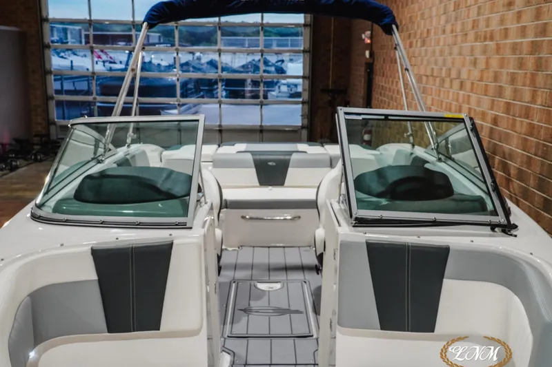 Slide: The Image of 2023 Chaparral 23 SSi boat interior with open windshield and seating. - 6
