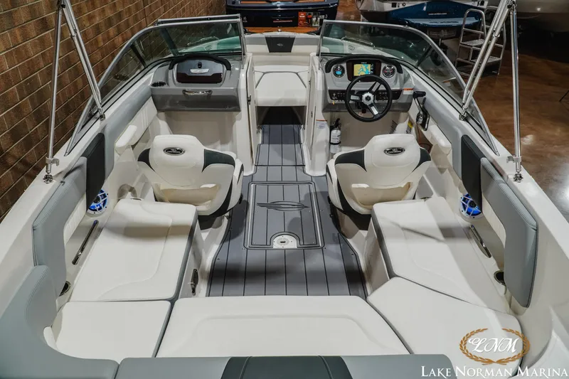 Slide: The Image of 2023 Chaparral 23 SSi boat interior with modern seating and dashboard at Lake Norman Marina. - 9