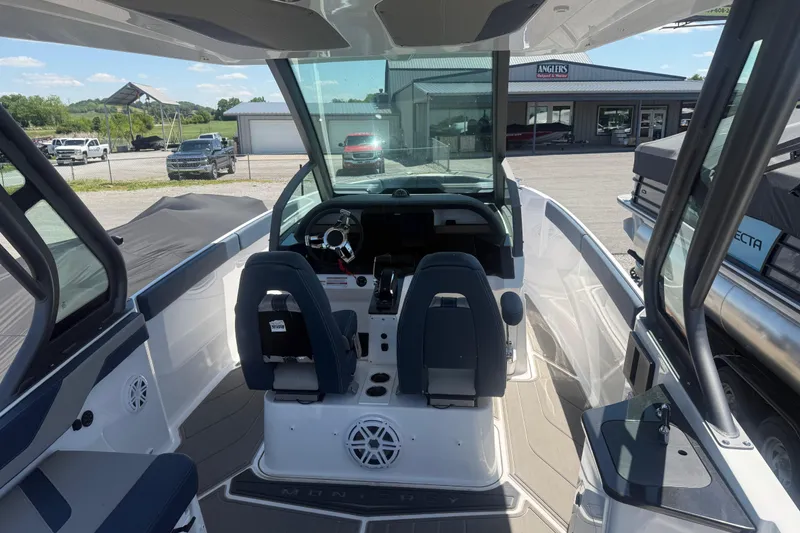 Slide: The Image of 2025 Monterey Elite 27 OB boat interior with dual seats and modern dashboard. - 13