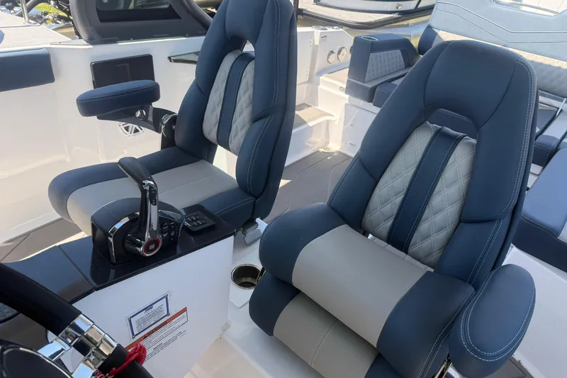 Slide: The Image of 2025 Monterey Elite 27 OB boat interior with luxurious blue and gray seating. - 16