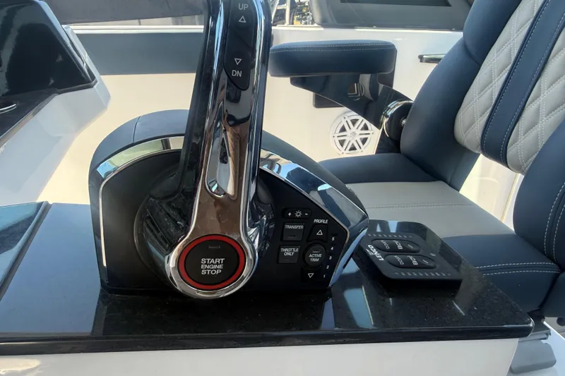 Slide: The Image of Throttle control panel of 2025 Monterey Elite 27 OB boat with start/stop button. - 17