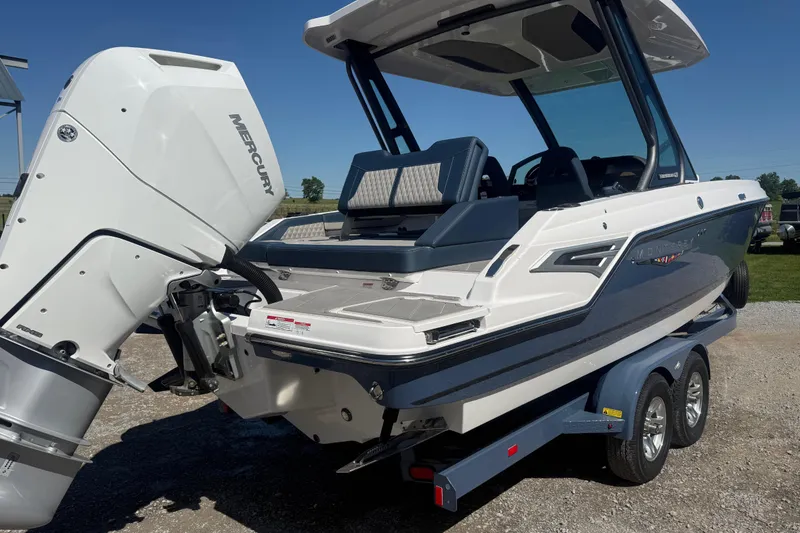 Slide: The Image of 2025 Monterey Elite 27 OB boat with Mercury outboard engine on trailer, sunny day. - 6