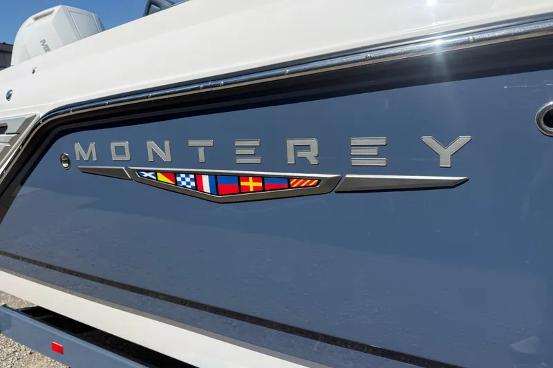 Slide: The Image of 2025 Monterey Elite 27 OB boat with sleek design and nautical flag accents. - 8