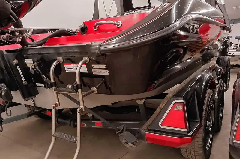 Slide: The Image of 2024 Ranger 621FS Fisherman boat rear view with ladder and trailer. - 14
