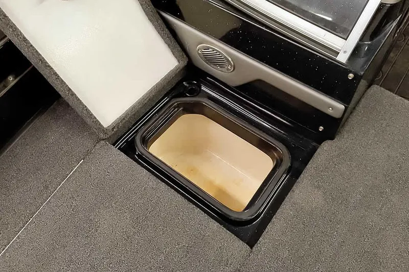 Slide: The Image of 2024 Ranger 621FS Fisherman boat storage compartment with open lid, showcasing interior space. - 18