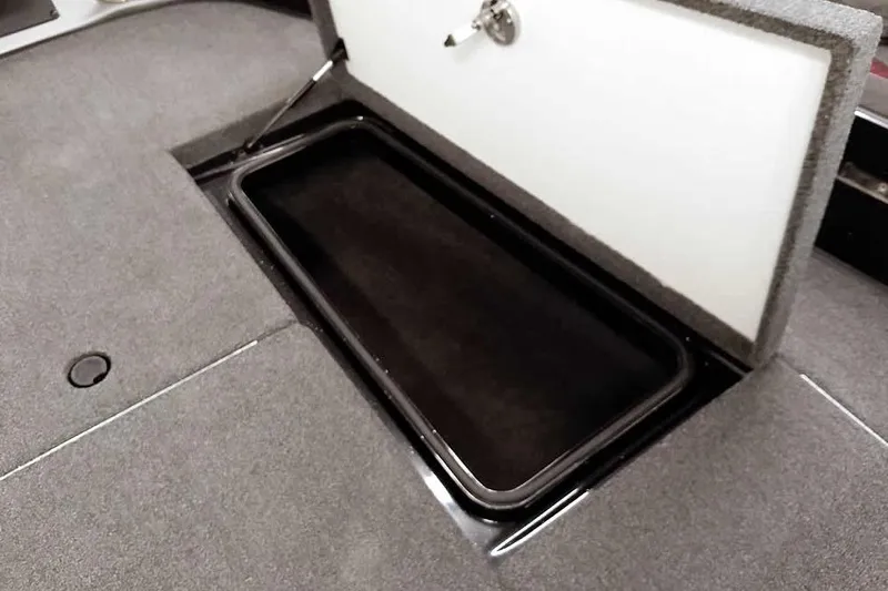 Slide: The Image of 2024 Ranger 621FS Fisherman boat storage compartment with open lid. - 19