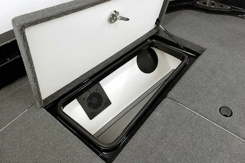 Slide: The Image of Open storage compartment in 2024 Ranger 621FS Fisherman boat, featuring carpeted interior. - 20