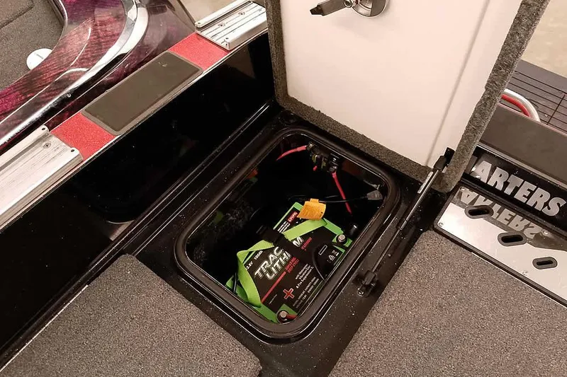 Slide: The Image of Open battery compartment in 2024 Ranger 621FS Fisherman boat, showcasing lithium battery setup. - 37
