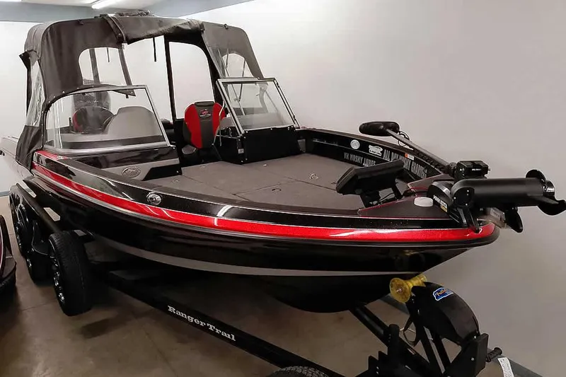 Slide: The Image of 2024 Ranger 621FS Fisherman boat with canopy, displayed indoors on a trailer. - 41