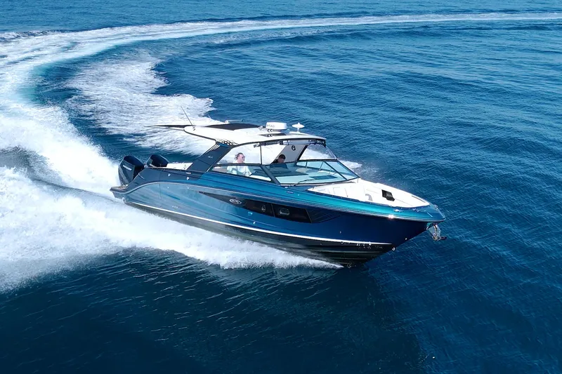 Slide: The Image of 2021 Sea Ray SLX 400 Outboard cruising on open blue water. - 12