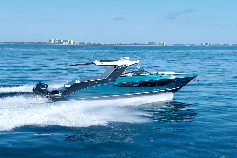 Slide: The Image of 2021 Sea Ray SLX 400 Outboard cruising on open water, city skyline in background. - 13