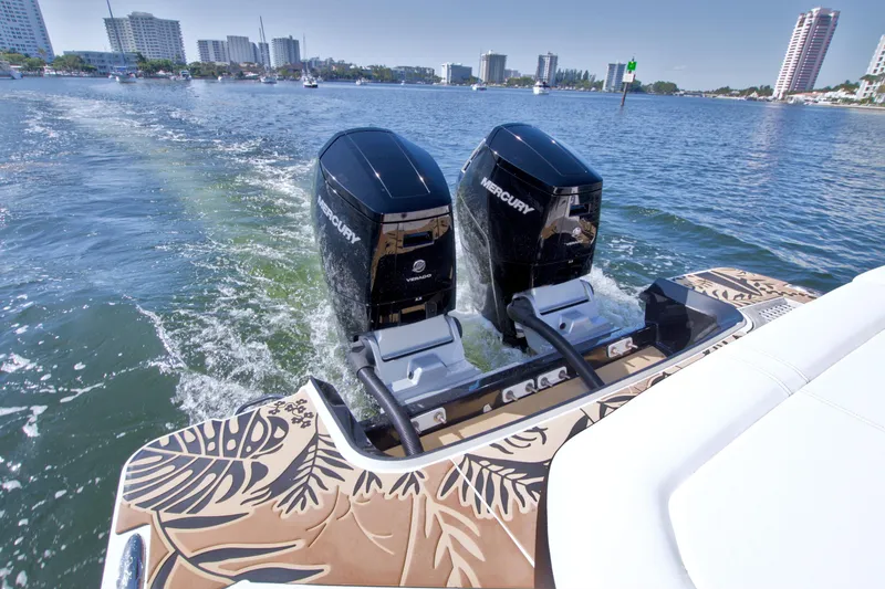 Slide: The Image of 2021 Sea Ray SLX 400 Outboard cruising with twin Mercury engines on a sunny day. - 14