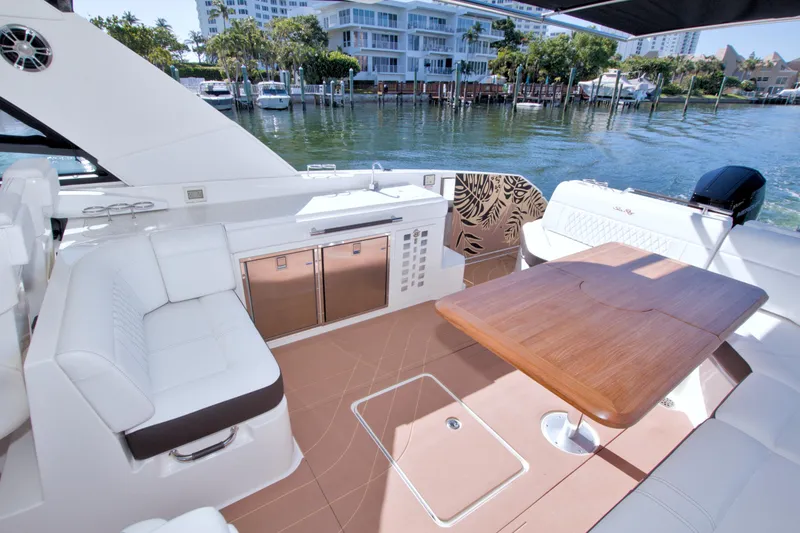 Slide: The Image of Luxurious 2021 Sea Ray SLX 400 Outboard yacht interior with seating and wooden table. - 22