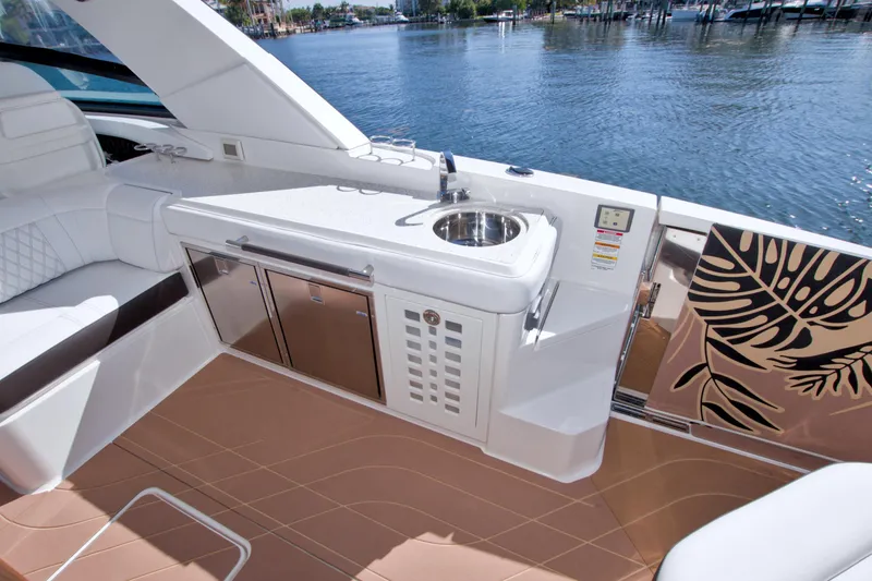 Slide: The Image of Luxurious 2021 Sea Ray SLX 400 Outboard yacht interior with sleek kitchenette and waterfront view. - 24