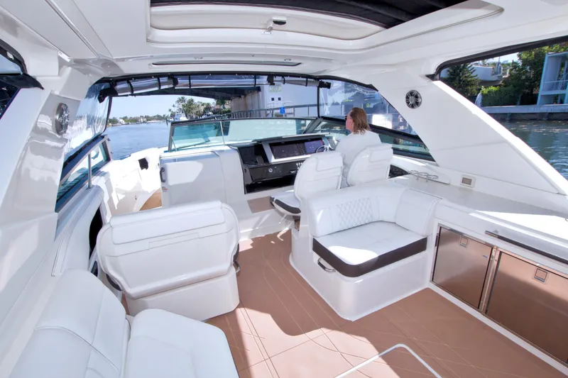 Slide: The Image of Luxurious 2021 Sea Ray SLX 400 Outboard interior with white seating and modern helm. - 25