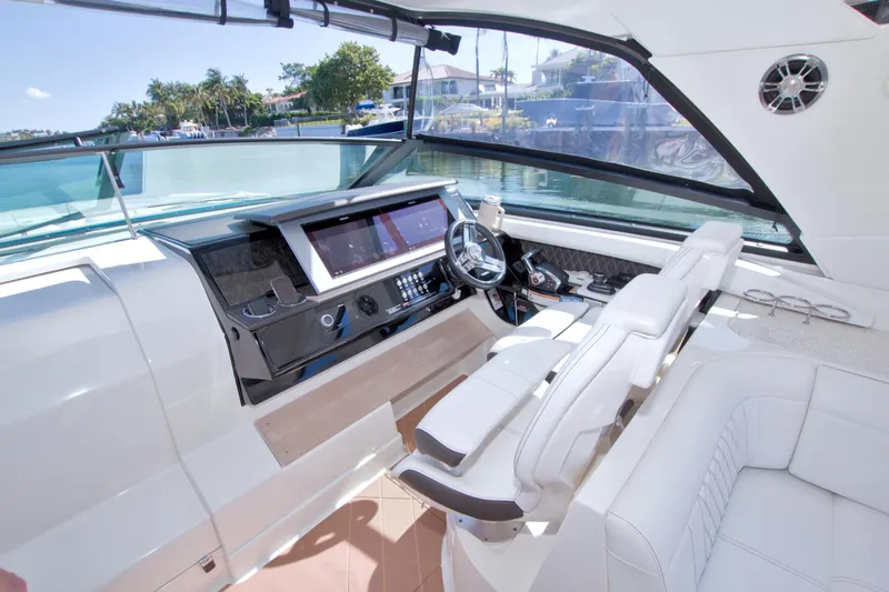 Slide: The Image of Luxurious helm of 2021 Sea Ray SLX 400 Outboard with modern controls and seating. - 28