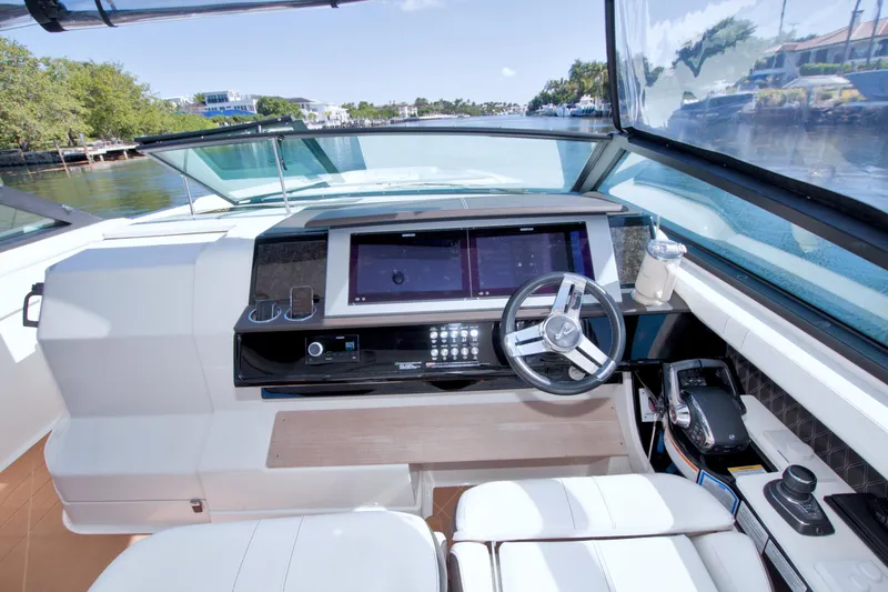 Slide: The Image of 2021 Sea Ray SLX 400 Outboard helm with modern controls and dual screens. - 29