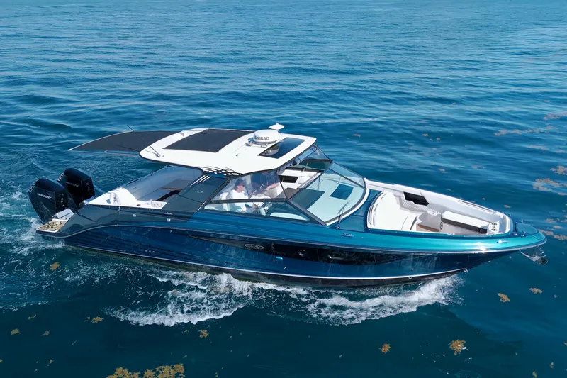 Slide: The Image of 2021 Sea Ray SLX 400 Outboard cruising on clear blue water. - 3