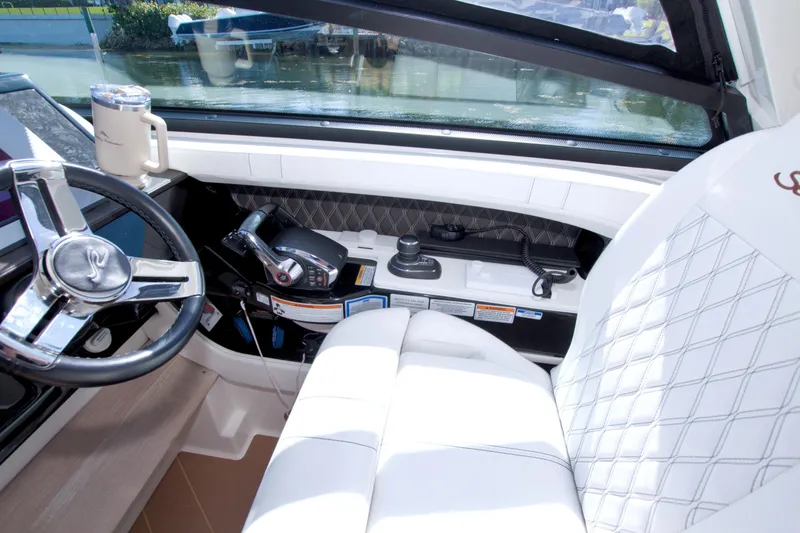 Slide: The Image of Interior of 2021 Sea Ray SLX 400 Outboard boat with steering wheel and controls. - 30