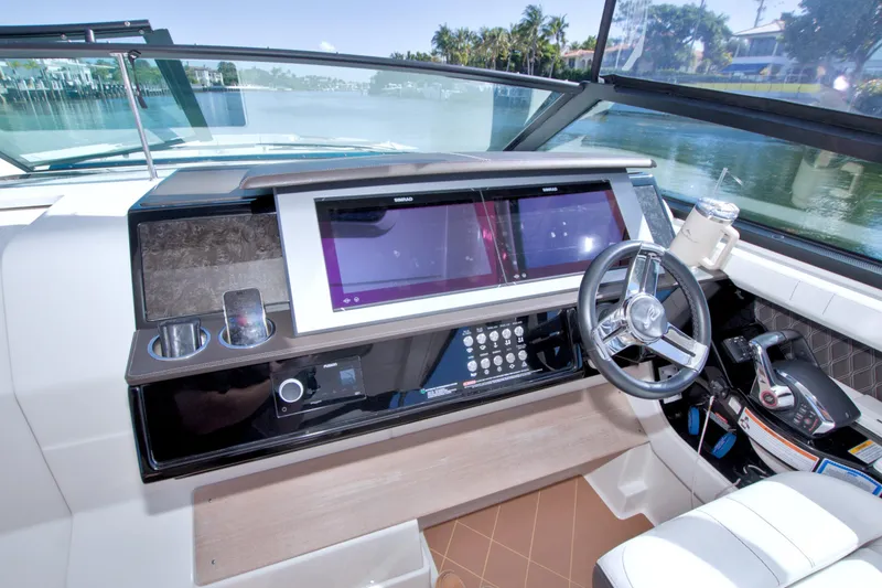 Slide: The Image of 2021 Sea Ray SLX 400 Outboard helm with dual screens and modern controls. - 31
