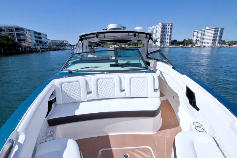 Slide: The Image of 2021 Sea Ray SLX 400 Outboard cruising on a sunny day near waterfront buildings. - 36