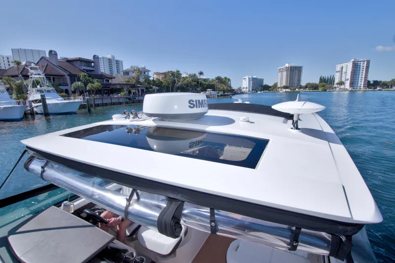 Slide: The Image of 2021 Sea Ray SLX 400 Outboard cruising near waterfront buildings under clear blue sky. - 38