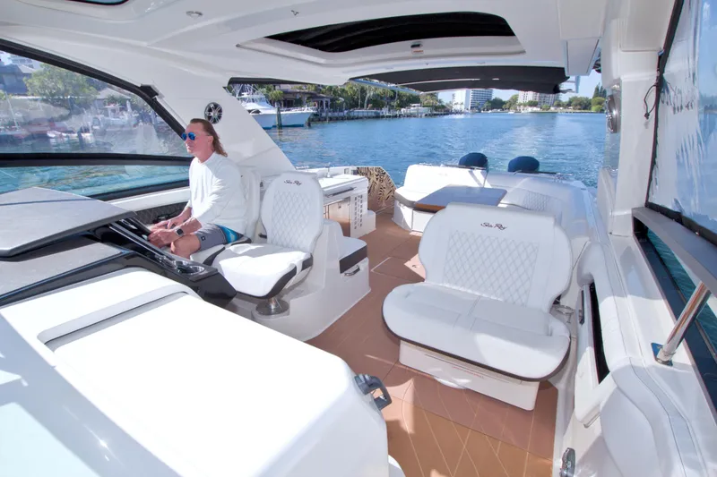 Slide: The Image of 2021 Sea Ray SLX 400 Outboard cruising on a sunny day, featuring luxurious seating and modern design. - 40