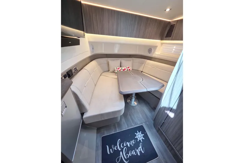 Slide: The Image of Luxurious interior of 2021 Sea Ray SLX 400 Outboard with cozy seating and table. - 47