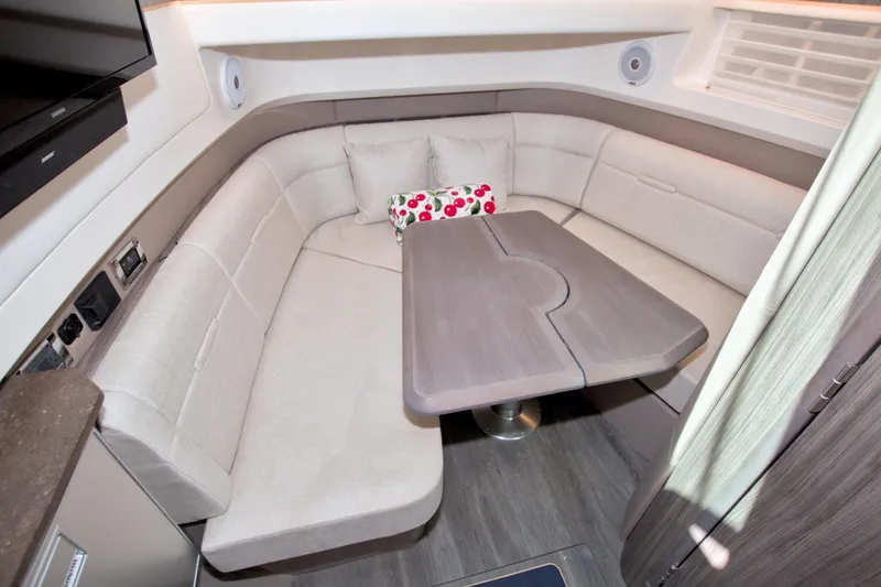 Slide: The Image of 2021 Sea Ray SLX 400 Outboard interior with cozy seating and table. - 48