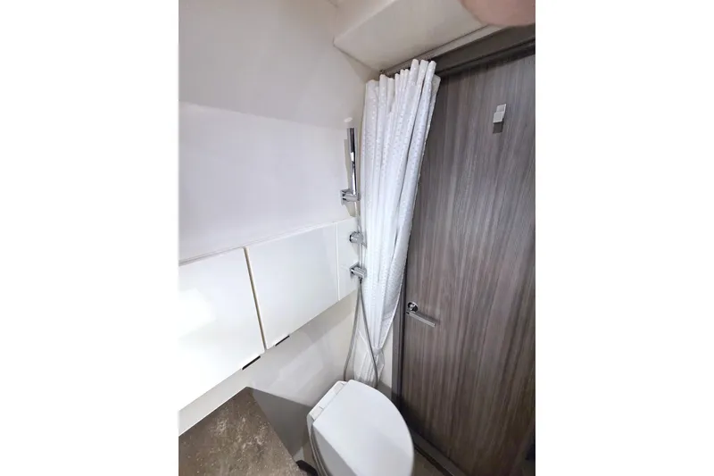 Slide: The Image of Bathroom interior of 2021 Sea Ray SLX 400 Outboard with shower and toilet. - 52
