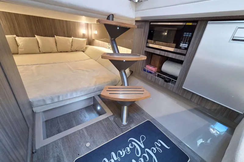 Slide: The Image of Luxurious interior of 2021 Sea Ray SLX 400 Outboard with bed, stairs, and kitchenette. - 53