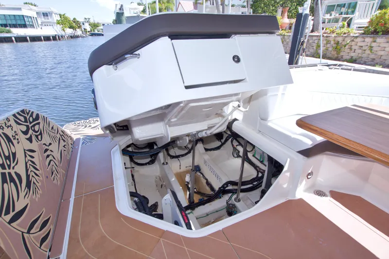 Slide: The Image of 2021 Sea Ray SLX 400 Outboard engine compartment, open hatch, dockside view. - 58