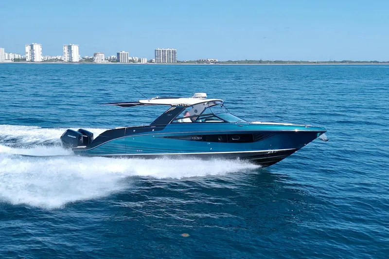 Slide: The Image of 2021 Sea Ray SLX 400 Outboard cruising on open water, city skyline in background. - 6