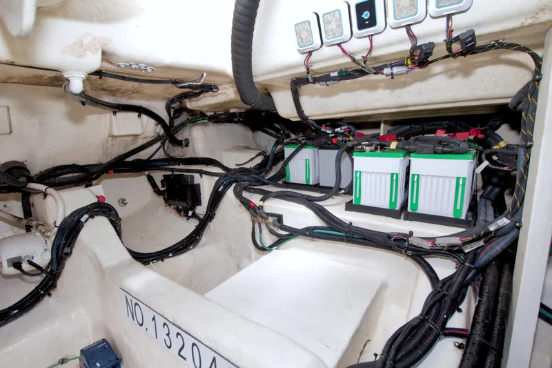 Slide: The Image of 2021 Sea Ray SLX 400 Outboard battery compartment with wiring and electrical components. - 64