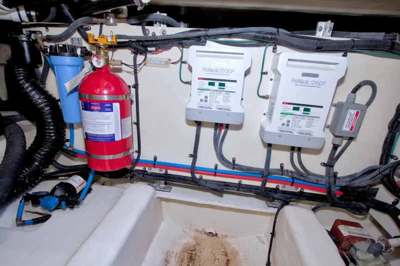 Slide: The Image of Engine compartment of 2021 Sea Ray SLX 400 Outboard with fire extinguisher and electrical systems. - 67