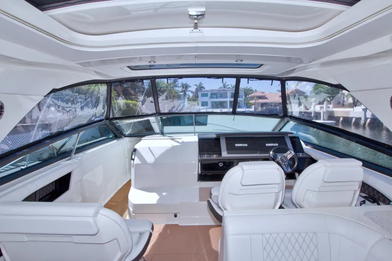 Slide: The Image of Interior view of 2021 Sea Ray SLX 400 Outboard boat with luxurious seating and modern dashboard. - 68