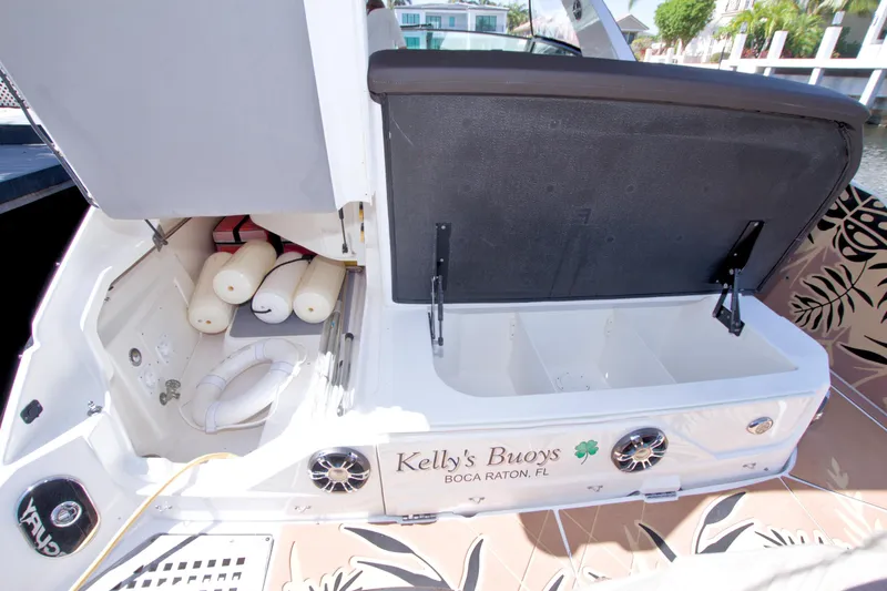 Slide: The Image of 2021 Sea Ray SLX 400 Outboard boat storage area with open compartments and safety equipment. - 69
