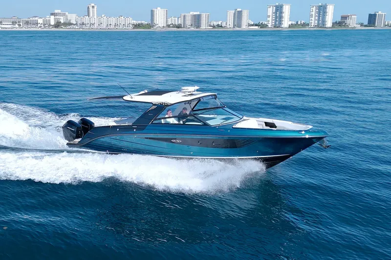 Slide: The Image of 2021 Sea Ray SLX 400 Outboard cruising on blue ocean near city skyline. - 7